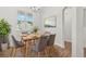 An interior view of the dining room with a wooden table and grey upholstered chairs at 2348 Bigwood Trl, Atlanta, GA 30349