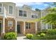 Inviting exterior view of charming townhome with stone accents, a covered entrance, and manicured lawn at 2348 Bigwood Trl, Atlanta, GA 30349