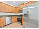 Well-equipped kitchen with stainless steel appliances, granite countertops, and ample wood cabinet storage at 2348 Bigwood Trl, Atlanta, GA 30349