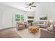 Inviting living room features neutral decor, fireplace, and large windows offering great natural light at 2348 Bigwood Trl, Atlanta, GA 30349