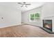 Living room featuring a fireplace, beautiful wood floors, and natural light at 2348 Bigwood Trl, Atlanta, GA 30349