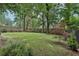 This spacious backyard features green grass and a well-maintained wooden privacy fence at 2411 Second Ave, Decatur, GA 30032
