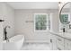 Bathroom featuring a soaking tub, marble floors, and a modern vanity at 2411 Second Ave, Decatur, GA 30032