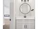Bathroom features a modern vanity with marble countertop and a stylish round mirror at 2411 Second Ave, Decatur, GA 30032