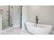 Elegant bathroom with a soaking tub, a walk-in shower, and marble floors at 2411 Second Ave, Decatur, GA 30032
