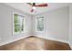 Light-filled bedroom with ceiling fan, hardwood floors, and two windows at 2411 Second Ave, Decatur, GA 30032