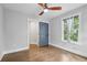Bedroom with a ceiling fan, hardwood floors, and a gray painted door at 2411 Second Ave, Decatur, GA 30032