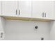 White cabinets with sleek black handles above laundry area at 2411 Second Ave, Decatur, GA 30032