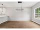 Bright dining area with hardwood floors, modern lighting and adjacent kitchen space at 2411 Second Ave, Decatur, GA 30032