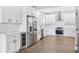 Spacious kitchen features stainless steel appliances, sleek white cabinets, and a wine cooler at 2411 Second Ave, Decatur, GA 30032