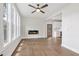 Spacious living room with hardwood floors, fireplace, and open layout into the kitchen at 2411 Second Ave, Decatur, GA 30032