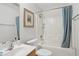 Bright bathroom featuring a vanity sink, framed mirror, and a shower-tub combination with a blue curtain at 2825 Ellenwood Village Way, Ellenwood, GA 30294