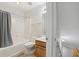 Cozy bathroom with a wooden vanity, neutral tile floor, and a shower-tub combination with a gray curtain at 2825 Ellenwood Village Way, Ellenwood, GA 30294