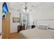Well-lit bedroom featuring a ceiling fan, mounted TV, and a plush bed with decorative pillows at 2825 Ellenwood Village Way, Ellenwood, GA 30294