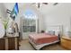 Bright bedroom with large arched window, soft carpet, and stylish furniture, creating a peaceful retreat at 2825 Ellenwood Village Way, Ellenwood, GA 30294