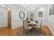 Bright dining room with hardwood floors, decorative mirror, chandelier, and modern furniture at 2825 Ellenwood Village Way, Ellenwood, GA 30294