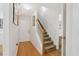 Inviting entryway featuring hardwood floors, a staircase with white banisters, and neutral-toned walls at 2825 Ellenwood Village Way, Ellenwood, GA 30294