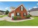 Charming brick home with well-manicured landscaping and a side-entry garage, showcasing curb appeal at 2825 Ellenwood Village Way, Ellenwood, GA 30294