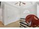 Bright home gym featuring carpet, ceiling fan, weight bench, and natural light from an arched window at 2825 Ellenwood Village Way, Ellenwood, GA 30294