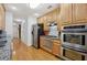 Well-designed kitchen with stainless steel appliances, granite countertops, hardwood floors and ample cabinet space at 2825 Ellenwood Village Way, Ellenwood, GA 30294