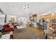 Open-concept living room with hardwood floors, modern furniture, and seamless flow to the dining and kitchen at 2825 Ellenwood Village Way, Ellenwood, GA 30294