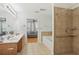 Well-appointed bathroom featuring double sinks, tiled shower, and tub, adjacent to a cozy sitting room at 2825 Ellenwood Village Way, Ellenwood, GA 30294