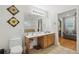 Elegant main bathroom with a double vanity, large mirror, and access to a soaking tub area at 2825 Ellenwood Village Way, Ellenwood, GA 30294