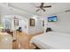 Expansive main bedroom featuring tray ceilings, wood floors, a sitting area, and ensuite bathroom at 2825 Ellenwood Village Way, Ellenwood, GA 30294