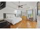 Spacious main bedroom with tray ceiling, wood floors, and plenty of natural light from large windows at 2825 Ellenwood Village Way, Ellenwood, GA 30294