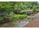 Picturesque creek flowing through a verdant landscape with lush trees and vegetation at 3280 Stillhouse Se Ln # 212, Atlanta, GA 30339