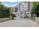 Elegant condo building featuring a stone facade, landscaped entrance, and secure access at 3280 Stillhouse Se Ln # 212, Atlanta, GA 30339