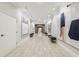 Well-lit hallway with tiled floor, recessed lighting, and decorative art at 3280 Stillhouse Se Ln # 212, Atlanta, GA 30339