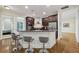 Open kitchen with breakfast bar, granite counters, stainless appliances, and wood floors at 3280 Stillhouse Se Ln # 212, Atlanta, GA 30339
