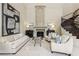 Spacious living room with fireplace, comfortable seating, and elegant staircase at 3280 Stillhouse Se Ln # 212, Atlanta, GA 30339