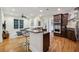 Open living space with breakfast bar, modern ceiling fan, and wood flooring throughout at 3280 Stillhouse Se Ln # 212, Atlanta, GA 30339