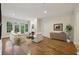 Bright living room features hardwood floors, fireplace, and large windows with a view at 3280 Stillhouse Se Ln # 212, Atlanta, GA 30339