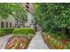 Landscaped walkway with colorful flowers and lush greenery leading to the property at 3280 Stillhouse Se Ln # 212, Atlanta, GA 30339