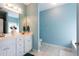 Bright bathroom with double sinks, large mirror, and separate toilet and shower areas at 381 Crossroads Dr, Social Circle, GA 30025