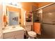 Bright bathroom featuring a vanity, open shelving, toilet and glass enclosed shower at 381 Crossroads Dr, Social Circle, GA 30025