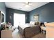 Stylishly decorated bedroom with a comfortable bed, side table, and wall decor at 381 Crossroads Dr, Social Circle, GA 30025
