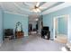 Spacious bedroom offering a walk-in closet, tray ceiling and access to a bathroom at 381 Crossroads Dr, Social Circle, GA 30025