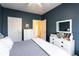 Bedroom featuring white dressers and a view to a neutral colored hallway at 381 Crossroads Dr, Social Circle, GA 30025