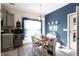 Charming dining area with natural light, stylish decor, and a calming blue accent wall for a cozy atmosphere at 381 Crossroads Dr, Social Circle, GA 30025