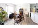 Bright dining area with a wooden table, decorative chandelier, and access to kitchen area, perfect for entertaining at 381 Crossroads Dr, Social Circle, GA 30025