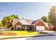 Beautiful brick home boasts mature trees, a manicured lawn, and an attached two-car garage at 381 Crossroads Dr, Social Circle, GA 30025