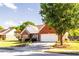 Charming brick home with manicured lawn, blooming flower beds, and a two-car garage at 381 Crossroads Dr, Social Circle, GA 30025