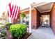 Charming front porch with brick facade, American flag, and lush landscaping at 381 Crossroads Dr, Social Circle, GA 30025