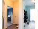 Hallway view to bedrooms featuring neutral walls, hardwood flooring, and inviting doorways into other rooms at 381 Crossroads Dr, Social Circle, GA 30025