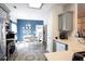 Modern kitchen with stainless steel appliances, light countertops, and a view into a vibrant dining area at 381 Crossroads Dr, Social Circle, GA 30025