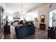 Cozy living room features a fireplace, vaulted ceiling, and wood flooring with a view into kitchen area at 381 Crossroads Dr, Social Circle, GA 30025